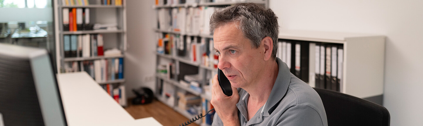 Employee on the phone at his desk